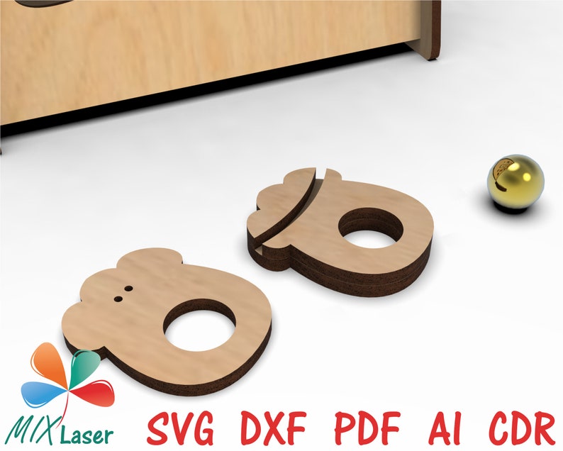 May include: Two wooden ring holders, one shaped like a foot and the other like a mitten, are shown on a white surface. A gold ball is also visible in the background.