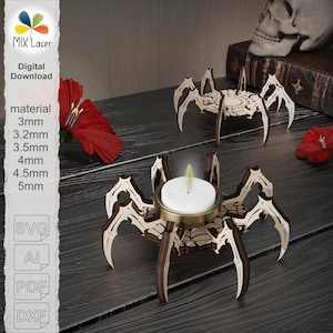 May include: Wooden spider-shaped candle holders with a laser-cut design. One holds a lit candle in a gold-colored cup. The image also shows a skull, red flowers, and text that says "MIX Laser Digital Download" and "material 3mm 3.2mm 3.5mm 4mm 4.5mm 5mm".