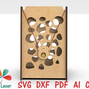 May include: A wooden toy with a string and a small bear-shaped piece with a ball inside. The toy has a pattern of holes cut out of the wood.