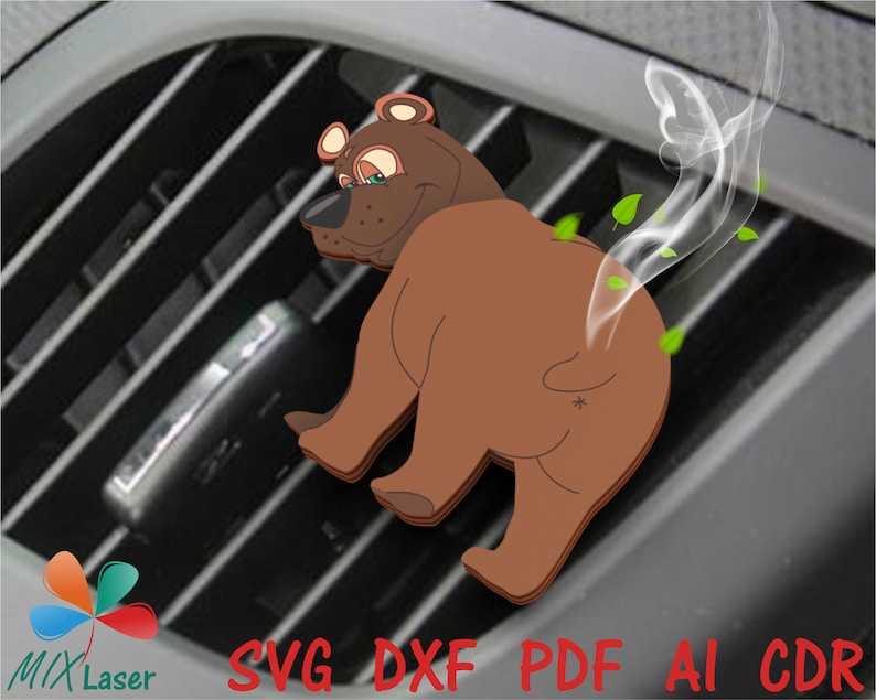 May include: A brown bear air freshener with a cartoon face and a cloud of smoke coming from its rear end. The bear is sitting in a car's air vent.