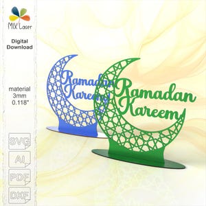 May include: Two laser-cut Ramadan Kareem decorations. One is blue, the other green. Each features a crescent moon design with intricate geometric patterns and the words "Ramadan Kareem" in script. The material is 3mm or 0.118 inches thick.