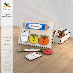 May include: Wooden perpetual calendar with a pencil design, featuring the month of December. Includes apple-shaped date markers and a small wooden box. The calendar also has the months of March, and the days of the week.