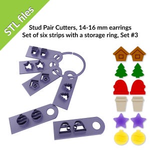 Könnte beinhalten: Satz mit sechs violetten Kunststoff-Ohrring-Ausschneidern mit einem Aufbewahrungsring. Die Ausschneider sind in Form verschiedener Weihnachtsornamente gestaltet, darunter ein Stern, ein Haus, ein Baum, eine Kaffeetasse, eine Glocke und ein Ornament. Die Ausschneider sind für das Ausschneiden von Ohrringen mit 14-16 mm Durchmesser ausgelegt. STL-Dateien.