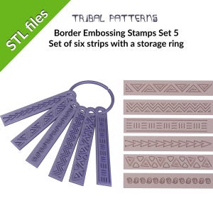 May include: Set of six purple plastic border embossing stamps with tribal patterns. The stamps are attached to a ring for storage.  The patterns include zigzags, triangles, and swirls.