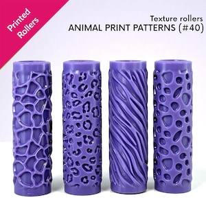 Op de afbeelding: Vier paarse textuurrollers met dierenprintpatronen. De rollers hebben ontwerpen met luipaardvlekken, zebra strepen en andere organische vormen. De tekst "Printed Rollers" en "ANIMAL PRINT PATTERNS (#40)" is zichtbaar.