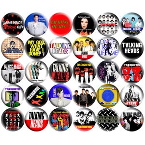 May include: A collection of Talking Heads band button pins. The pins feature images of the band members, album art, and text such as "Psycho Killer" and "Fear of Music". The pins are round and have a glossy finish.