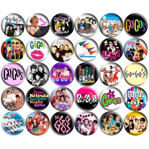 May include: A collection of round pinback buttons featuring The Go-Go's band. The buttons display various images of the band, album art, and the band's logo in vibrant colors like pink, black, and blue. Some buttons have text like "We Got the Beat!"