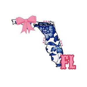 May include: A blue and white floral patterned outline of the state of Florida with a pink bow on the top left corner and the letters "FL" in pink below the outline.