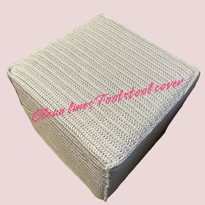 May include: A grey crocheted footstool cover with a ribbed texture. The cover is square shaped and has a simple design.