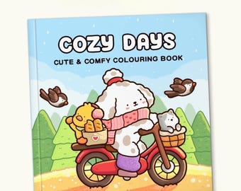 Puede incluir: Un libro para colorear "Cozy Days" con una linda ilustración de un perro blanco montando una bicicleta roja. El perro lleva una bufanda y un sombrero, con una cesta que contiene un pollito amarillo y pan. Un gato gris está en la cesta delantera. El fondo es azul.
