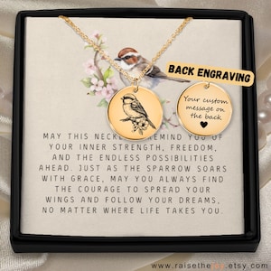 May include: A gold necklace with a round pendant featuring a sparrow illustration. The pendant is in a gift box with a message that reads "May this necklace remind you of your inner strength, freedom, and the endless possibilities ahead. Just as the sparrow soars with grace, may you always find the courage to spread your wings and follow your dreams, no matter where life takes you."