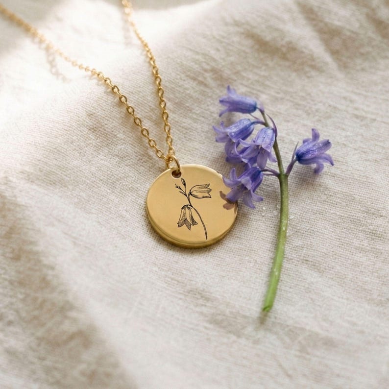 Bluebell birth flower necklace, gold plated engraved disc pendant on a dainty gold cable chain, personalized keepsake gift for her, front view