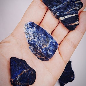 May include: Three rough, natural, blue and white, Sodalite crystal stones.