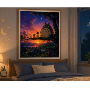 May include: A framed print of a sunset scene featuring a large, gray, cartoon-like creature with two smaller figures on a tree branch. The artwork has a warm color palette with a vibrant sunset and a crescent moon.