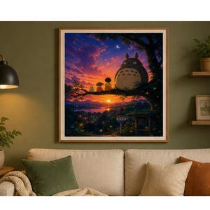 May include: A framed print of a sunset scene featuring the character Totoro and other figures sitting on a tree branch. The artwork has a warm color palette with a vibrant sky and a detailed landscape.