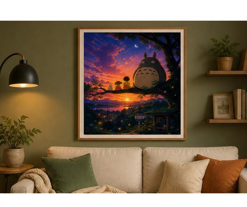 May include: A framed print of a sunset scene featuring the character Totoro and other figures sitting on a tree branch. The artwork has a warm color palette with a vibrant sky and a detailed landscape.