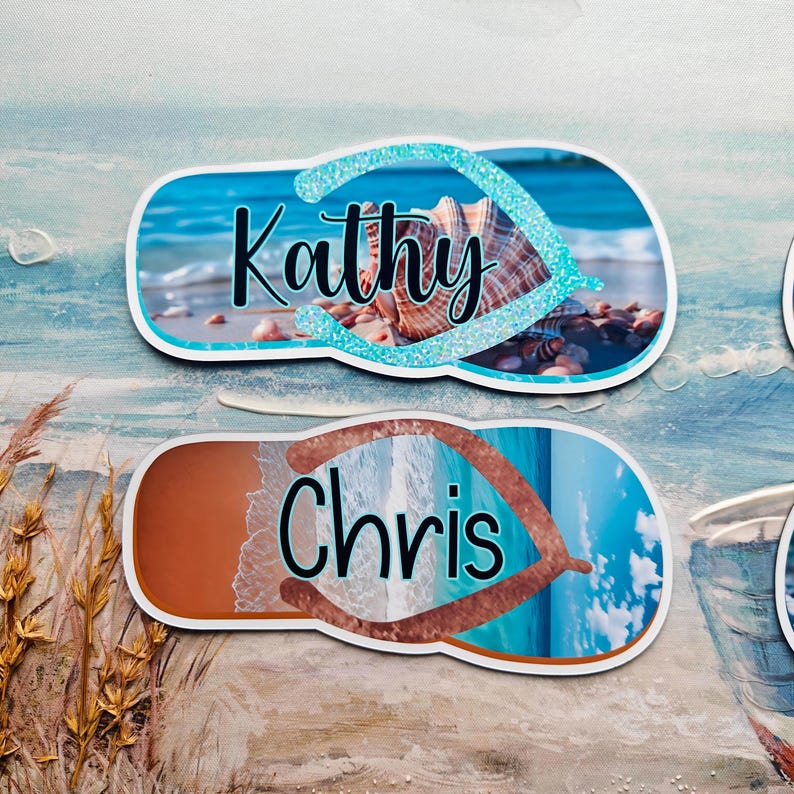 May include: Two personalised flip-flop-shaped name tags. One tag features the name "Kathy" in black script over a seashell image with a blue glitter border. The other tag has the name "Chris" over a beach scene.
