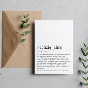 May include: A white card with black text that reads "Sechzig Jahre" and a definition of the word in German. The card is on a light gray background with green eucalyptus branches on either side.