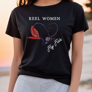 May include: Black t-shirt with the text "Reel Women Fly Fish'n" in white. The text is surrounded by a heart shape made of a fishing hook and a fly.