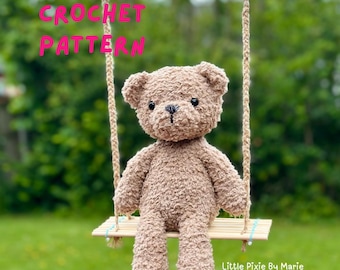 May include: A handmade brown teddy bear sits on a small wooden swing suspended by rope. The bear has a textured, fuzzy appearance with black button eyes and a stitched nose. The words "CROCHET PATTERN" are in pink text above the bear.