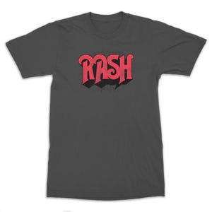May include: A dark gray t-shirt with a red "RASH" graphic in a retro font style.