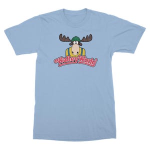 May include: Light blue t-shirt with a cartoon moose wearing a green hat and a yellow shirt. The text "Wally World" is printed in red and white below the moose.