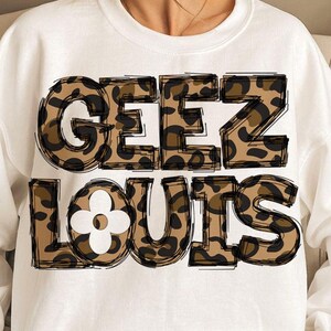 May include: White sweatshirt with a leopard print graphic that says "GEEZ LOUIS" with a white flower in the middle of the "O".