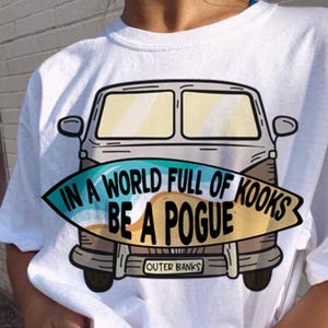 May include: White t-shirt with a graphic of a vintage van with a surfboard that says "In a world full of kooks be a Pogue" and "Outer Banks".