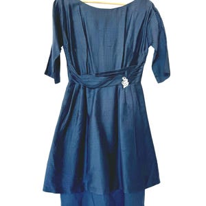 Rare 1950s style in this handmade navy, short sleeved, below the knee length, back zip fit and flare formal dress size 4/6, broach at waist
