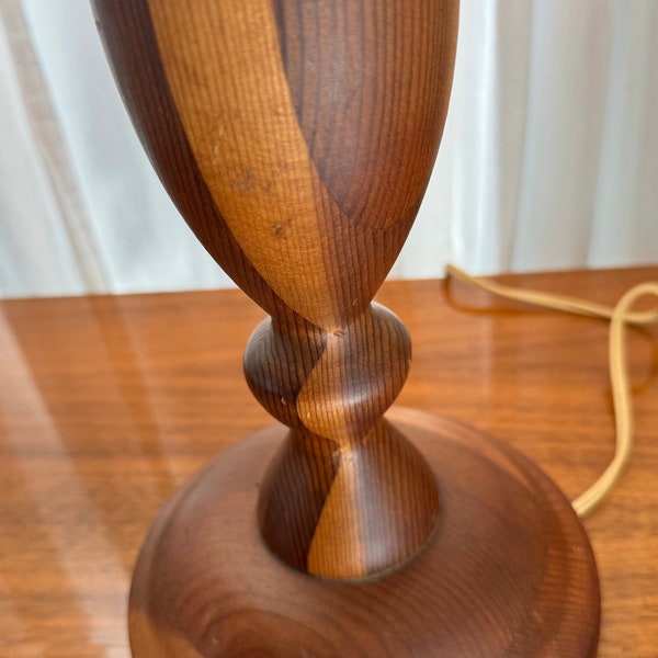 Vintage turned wood lamp with two tones of wood and graceful curved design. It works great, and is a nice medium-small size at 14.5" tall.