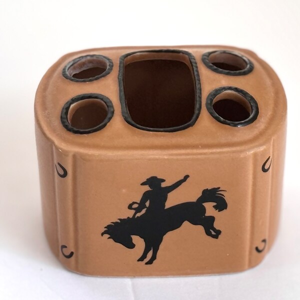Hello Cowboy! Vintage ceramic tooth brush holder. Brown with black horse and rider and horseshoe details. Holds 4 brushes, no visible flaws