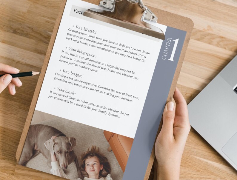 May include: A clipboard with a checklist of factors to consider when getting a pet. The checklist includes lifestyle, living space, budget, and family. The clipboard is on a wooden table with a laptop and a person's hand holding a pen.