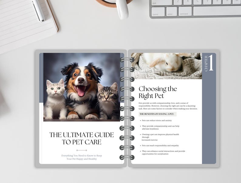 May include: An open notebook with a grey cover and white pages. The cover features a photo of a dog and two cats. The text on the cover reads "The Ultimate Guide to Pet Care" and "Everything You Need to Know to Keep Your Pet Happy and Healthy". The notebook also has a page with the title "Choosing the Right Pet" and a list of benefits of having a pet.