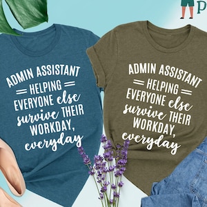 May include: Two t-shirts with the text "Admin Assistant = Helping = Everyone else survive their workday, everyday" printed in white on a teal and olive green background.