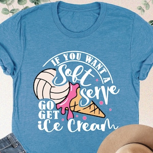May include: A blue t-shirt with a white graphic that says "If you want a soft serve go get ice cream". The graphic features a volleyball and an ice cream cone.