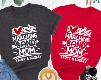 May include: Two t-shirts, one dark grey heather and one red, with a white graphic that says "I love marching band mom - busy & broke".