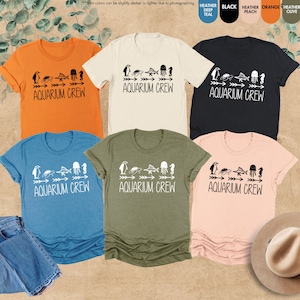 four t - shirts and a hat on a table