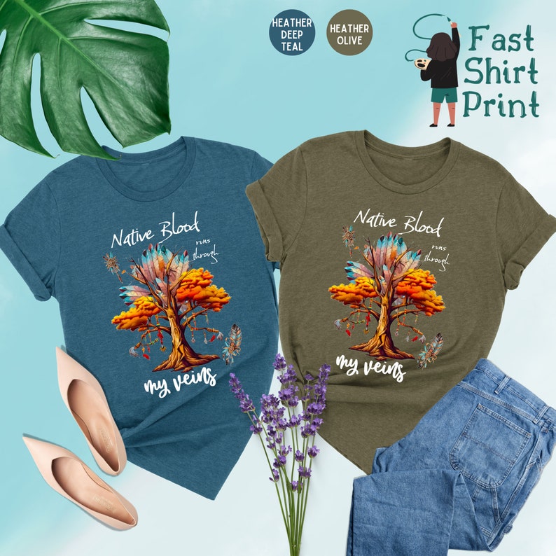 May include: Two t-shirts with a Native American design. The design features a tree with feathers and the text "Native Blood runs through my veins". The t-shirts are available in heather deep teal and heather olive.