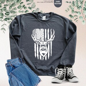 a black sweatshirt with an american flag and a deer's head