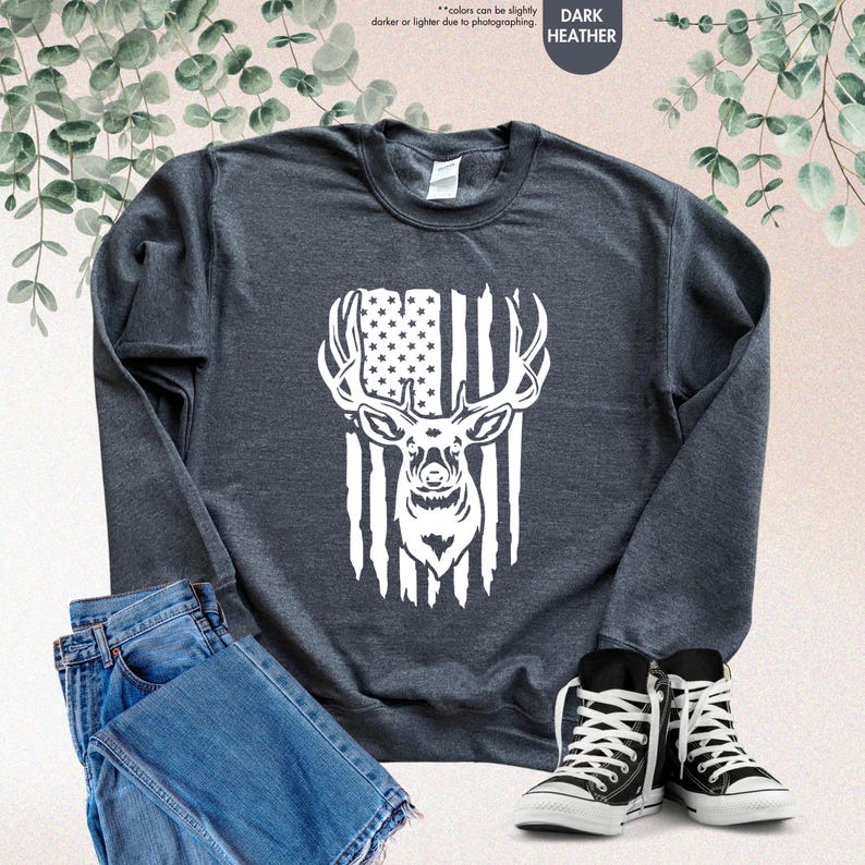 a black sweatshirt with an american flag and a deer's head
