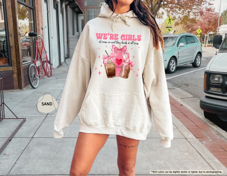 a woman wearing a hoodie with a cupcake on it