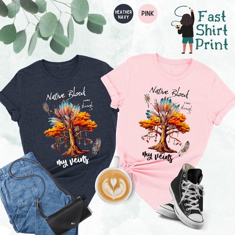 May include: Two t-shirts with a Native American design. The design features a tree with feathers and the text "Native Blood runs through my veins". The shirts are available in heather navy and pink.
