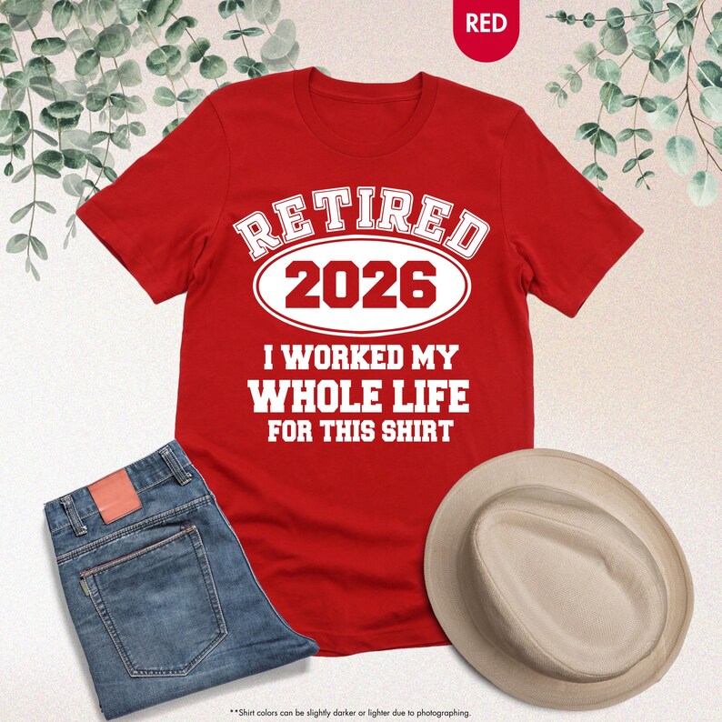 Puede incluir: Una camiseta roja con el texto blanco "RETIRED 2026 I WORKED MY WHOLE LIFE FOR THIS SHIRT". Se muestra con vaqueros azules y un sombrero beige. La imagen tiene un fondo neutro.