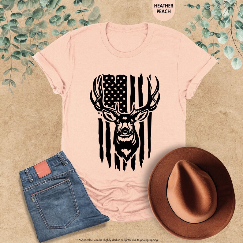 a pink shirt with an american flag and a deer's head