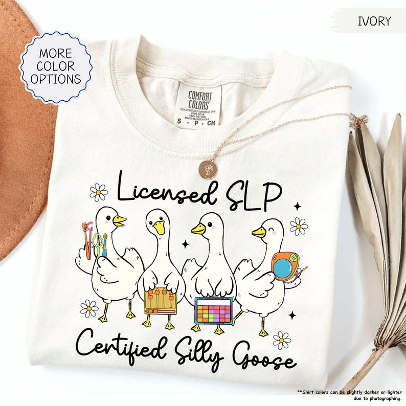 May include: Cream-coloured sweatshirt with the text "Licensed SLP" and "Certified Silly Goose." The graphic features four cartoon geese holding speech therapy tools. The shirt is a Comfort Colors brand.