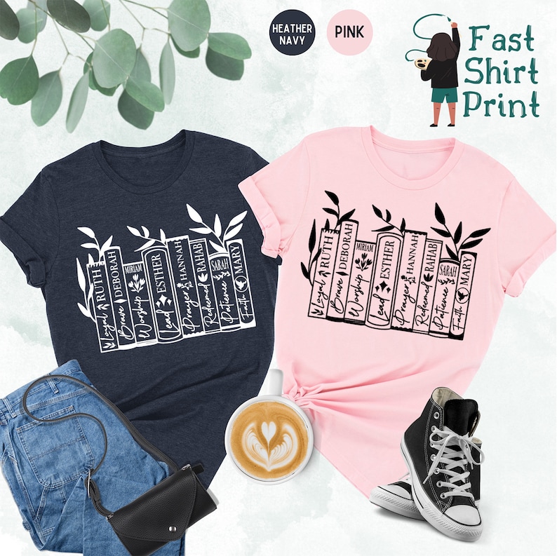 May include: Two t-shirts, one heather navy and one pink, with a white graphic of books and leaves. The books have words like "Loyal," "Ruth," and "Esther." The image also includes jeans, a black purse, a coffee cup, and a pair of black sneakers.