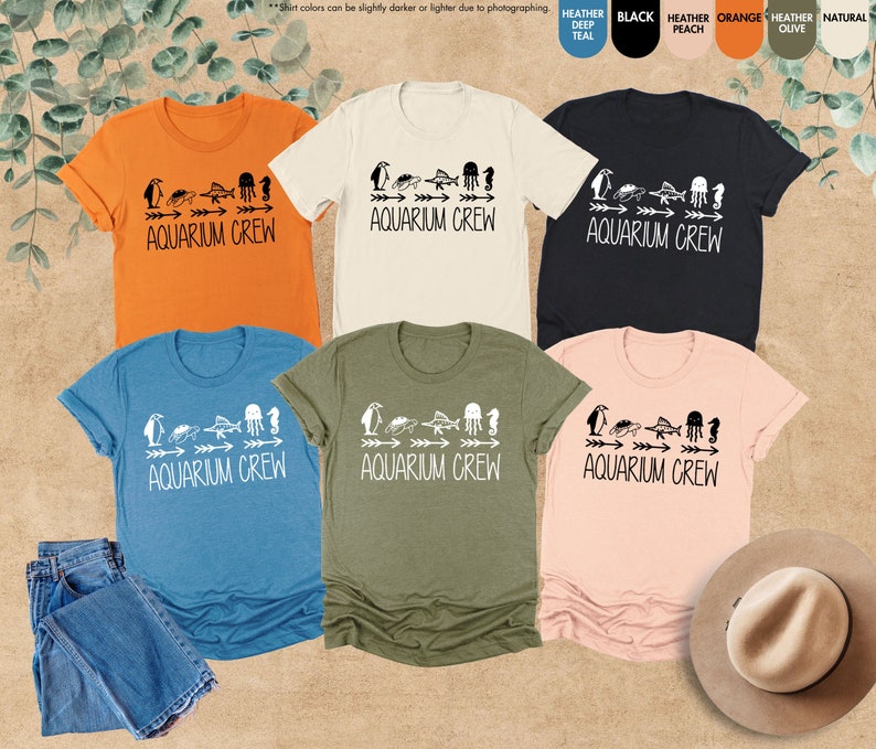 four t - shirts and a hat on a table