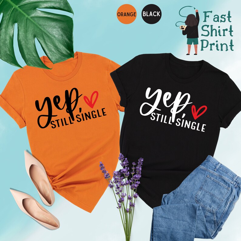 May include: Two t-shirts, one orange and one black, with the text "yep still single" and a red heart.