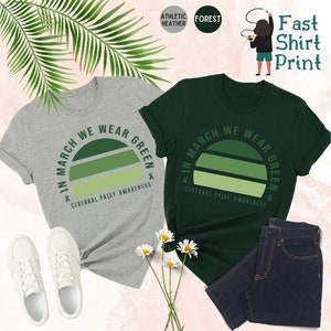 May include: Two t-shirts with a green sunset graphic and the text "In March We Wear Green" and "Cerebral Palsy Awareness".