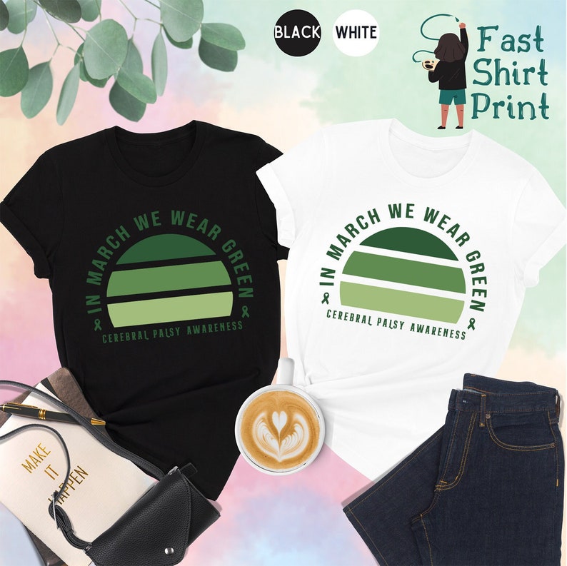 May include: Two t-shirts, one black and one white, with a green sunset graphic and the text "In March We Wear Green & Cerebral Palsy Awareness".